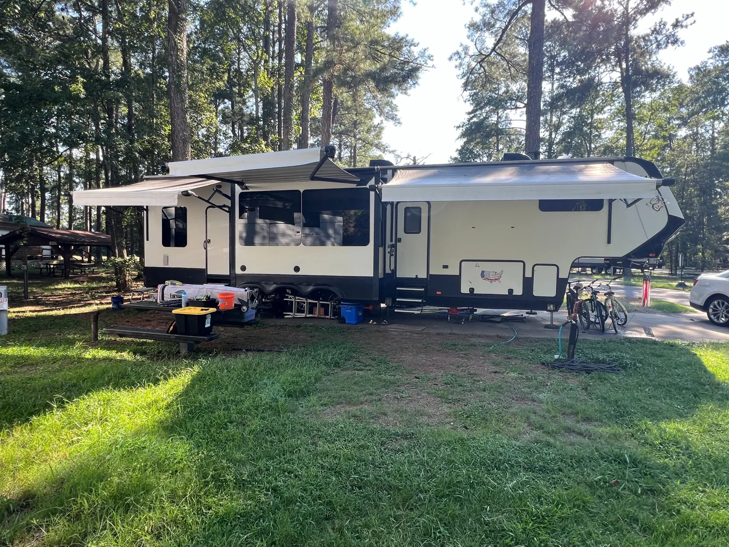 Our Grand Design fifth wheel set up in a wooded campground